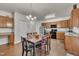 Charming eat-in kitchen features wood cabinets, stainless steel appliances, and a dining table at 111 S Rose Hill Dr, Clayton, NC 27520