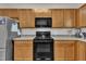 Functional kitchen features wood cabinets, stainless steel appliances, and stylish backsplash at 111 S Rose Hill Dr, Clayton, NC 27520