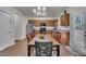 Bright eat-in kitchen boasts wood cabinetry, stainless steel appliances, and a stylish chandelier at 111 S Rose Hill Dr, Clayton, NC 27520