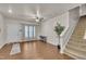 Bright living room boasts hardwood floors, neutral walls, ceiling fan and carpeted stairs at 111 S Rose Hill Dr, Clayton, NC 27520