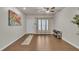 Bright living room boasts hardwood floors, neutral walls, ceiling fan and carpeted stairs at 111 S Rose Hill Dr, Clayton, NC 27520