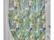 Close-up of a vibrant, tropical-themed shower curtain with green, yellow, and blue leaf patterns at 111 S Rose Hill Dr, Clayton, NC 27520