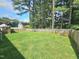 Spacious backyard featuring a well-maintained lawn, fenced perimeter, and mature trees at 112 Saddletree Rd, Oxford, NC 27565