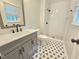 Updated bathroom with stylish black and white tiles and modern fixtures offers a fresh look at 112 Saddletree Rd, Oxford, NC 27565