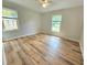 Bright bedroom featuring beautiful wood flooring, complemented by natural light streaming through the windows at 112 Saddletree Rd, Oxford, NC 27565