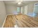 Neutral-toned bedroom with wooden floors and two doors offers a calm and inviting space at 112 Saddletree Rd, Oxford, NC 27565