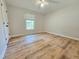 Bright bedroom featuring wood-look flooring, a ceiling fan, and a window with blinds at 112 Saddletree Rd, Oxford, NC 27565