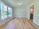 Sunlit dining area with a view into the kitchen, featuring sleek wooden floors and neutral decor at 112 Saddletree Rd, Oxford, NC 27565