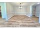 Open dining room with wood flooring, chair rail and a modern chandelier is perfect for entertaining at 112 Saddletree Rd, Oxford, NC 27565