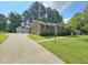 View of a brick home with a detached two car garage and plenty of driveway parking at 112 Saddletree Rd, Oxford, NC 27565