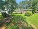 Charming front yard featuring lush landscaping and a well-maintained lawn at 112 Saddletree Rd, Oxford, NC 27565