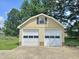 Exterior of two car garage with white doors, and a lush green lawn at 112 Saddletree Rd, Oxford, NC 27565