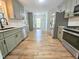 Updated kitchen with gray cabinets, stainless steel appliances, granite countertops and subway tile backsplash at 112 Saddletree Rd, Oxford, NC 27565