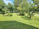 Beautiful yard with a lush green lawn and a variety of mature trees at 112 Saddletree Rd, Oxford, NC 27565