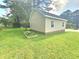 Exterior garage with a green yard and garden beds at 112 Saddletree Rd, Oxford, NC 27565