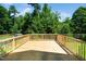 New wooden deck, perfect for outdoor entertaining, with lush greenery in the background at 11612 Leesville Rd, Raleigh, NC 27613