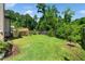Spacious backyard with lush green grass and a wooden deck, ideal for outdoor gatherings at 11612 Leesville Rd, Raleigh, NC 27613