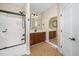 Well-lit bathroom with double vanity, bathtub shower combo, and tile floor at 11612 Leesville Rd, Raleigh, NC 27613