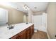 Bathroom features double sinks, wooden cabinets, and a shower/tub combo with a white curtain at 11612 Leesville Rd, Raleigh, NC 27613
