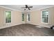 Inviting bedroom with hardwood floors, a ceiling fan, and bright windows at 11612 Leesville Rd, Raleigh, NC 27613