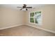 Sunny bedroom with carpet, ceiling fan, and a large window providing natural light at 11612 Leesville Rd, Raleigh, NC 27613