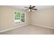 Inviting bedroom showcasing a ceiling fan, a bright window and soft, neutral decor at 11612 Leesville Rd, Raleigh, NC 27613