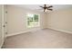 Cozy bedroom with soft carpet, ceiling fan, and bright window for ample light at 11612 Leesville Rd, Raleigh, NC 27613