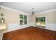 Dining room showcasing windows, wainscoting, and hardwood floors, leading to deck at 11612 Leesville Rd, Raleigh, NC 27613