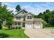 Inviting two-story home featuring a welcoming front porch and a spacious two-car garage at 11612 Leesville Rd, Raleigh, NC 27613