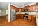 Modern kitchen featuring stainless steel appliances, granite countertops, and hardwood floors at 11612 Leesville Rd, Raleigh, NC 27613
