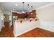 Open kitchen view with granite countertops, stainless steel appliances, and wood flooring at 11612 Leesville Rd, Raleigh, NC 27613