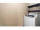 Functional laundry room with storage shelving and white washing machine at 11612 Leesville Rd, Raleigh, NC 27613