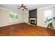 Spacious living room featuring a fireplace, hardwood floors, and lots of natural light at 11612 Leesville Rd, Raleigh, NC 27613