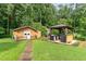 Backyard includes a shed with a porch and a gazebo with a grill, surrounded by lush greenery at 132 Lord Ashley Rd, Raleigh, NC 27610