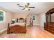Comfortable bedroom with wood flooring, wooden furniture, and natural light at 132 Lord Ashley Rd, Raleigh, NC 27610