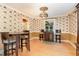 Cozy dining area featuring decorative wallpaper, hardwood floors, and stylish lighting at 132 Lord Ashley Rd, Raleigh, NC 27610