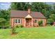 Inviting brick home with a well-kept lawn, small front porch, and charming curb appeal at 132 Lord Ashley Rd, Raleigh, NC 27610