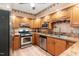 Functional kitchen featuring stainless steel appliances and plenty of wooden cabinet space at 132 Lord Ashley Rd, Raleigh, NC 27610