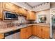 Well-lit kitchen featuring tiled countertops, stainless steel appliances, and ample cabinet space at 132 Lord Ashley Rd, Raleigh, NC 27610