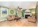 Comfortable living room featuring hardwood floors, a ceiling fan, and a cozy fireplace at 132 Lord Ashley Rd, Raleigh, NC 27610