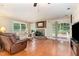 Inviting living room features a cozy fireplace and sliding glass doors to the outside deck at 132 Lord Ashley Rd, Raleigh, NC 27610