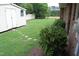 Lush backyard garden with a charming stone path and a storage shed, blending natural beauty with practicality at 1418 Sherron Rd, Durham, NC 27703