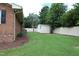 Spacious backyard featuring a storage shed and white fencing, perfect for secure outdoor enjoyment and storage solutions at 1418 Sherron Rd, Durham, NC 27703