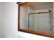 The bathroom features a glass-enclosed shower reflected in a wooden-framed mirror for a spa-like experience at 1418 Sherron Rd, Durham, NC 27703