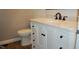 This bathroom offers a stylish vanity with marble countertop, dark fixtures, and a toilet, creating a modern space at 1418 Sherron Rd, Durham, NC 27703