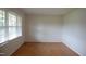 Bright, empty room with wood floors and lots of natural light from the windows at 1418 Sherron Rd, Durham, NC 27703