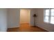 Cozy empty room with hardwood floors, natural light, and traditional baseboard trim at 1418 Sherron Rd, Durham, NC 27703