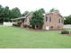 This lovely home showcases a brick exterior and well-manicured lawn, blending comfort with classic appeal at 1418 Sherron Rd, Durham, NC 27703