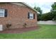 This home features a brick facade, complemented by a lush lawn and manicured landscaping, enhancing its outdoor charm at 1418 Sherron Rd, Durham, NC 27703