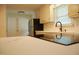 Renovated kitchen features black stainless fridge, bright lighting, and quartz countertops at 1418 Sherron Rd, Durham, NC 27703